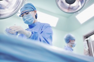 Nurse holding anesthesia mask in operating room